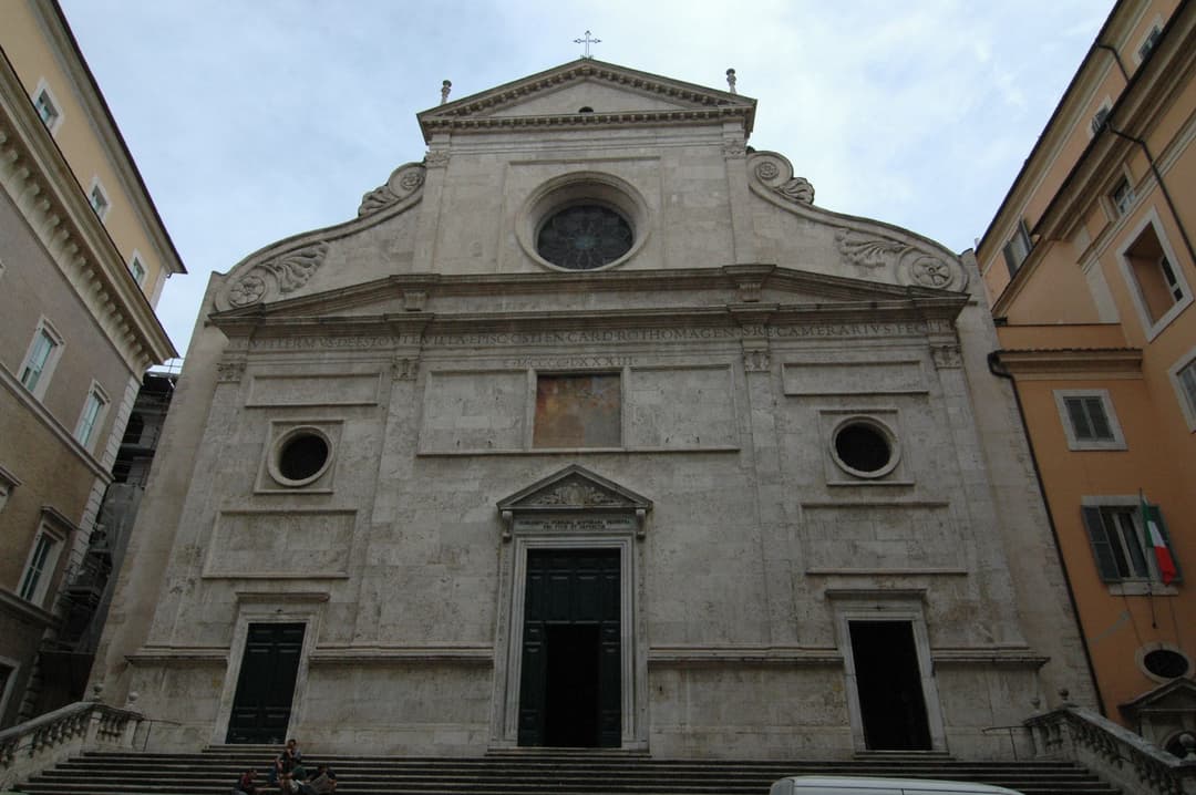 Low-angle view of the Renaissance travertine façade and entrance stairs