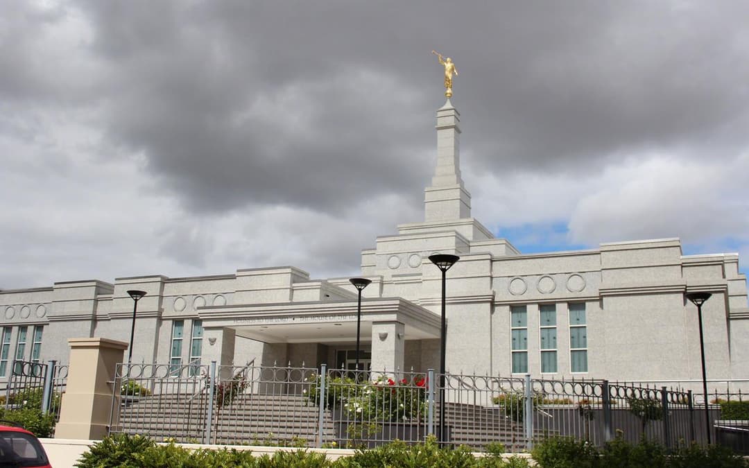 Perth Australia Temple, front view, golden Angel Moroni, cloudy sky.