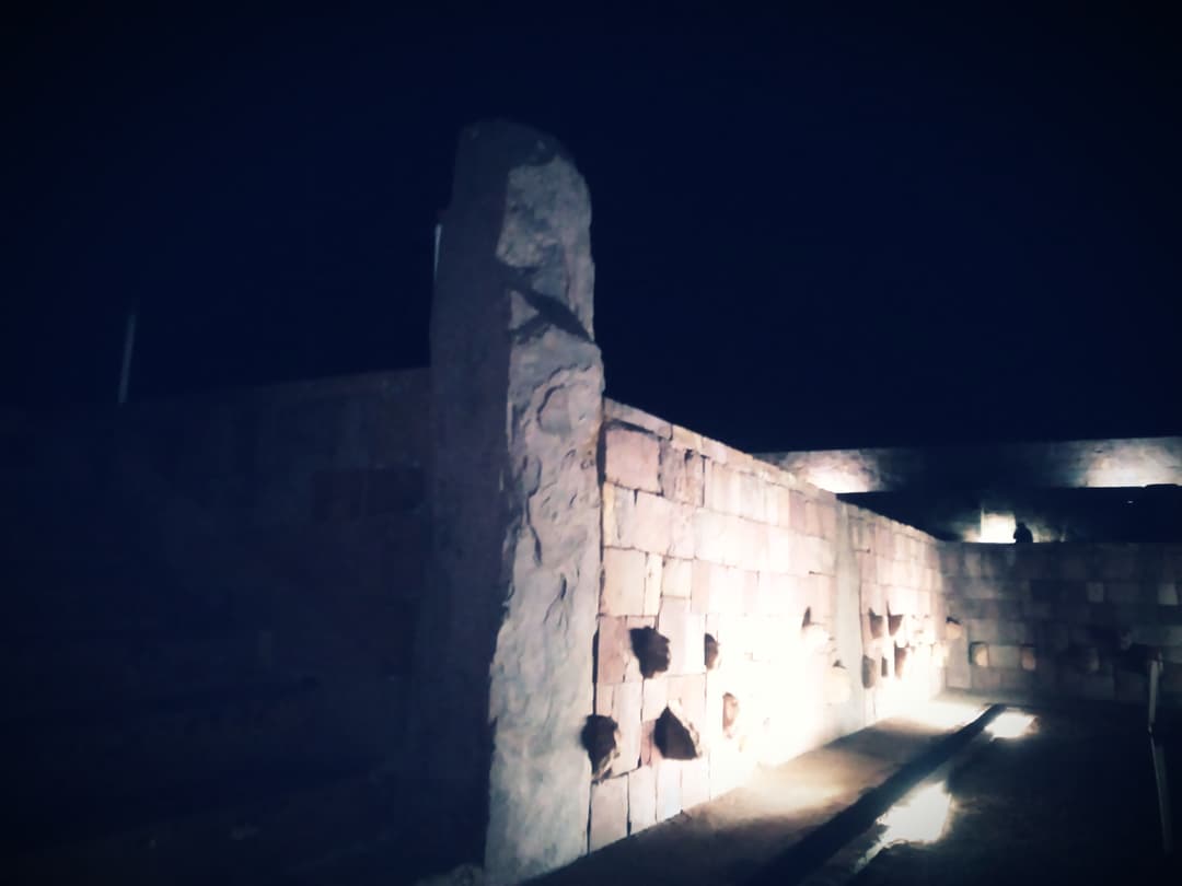 Illuminated stone wall of the Semi-Subterranean Temple at night