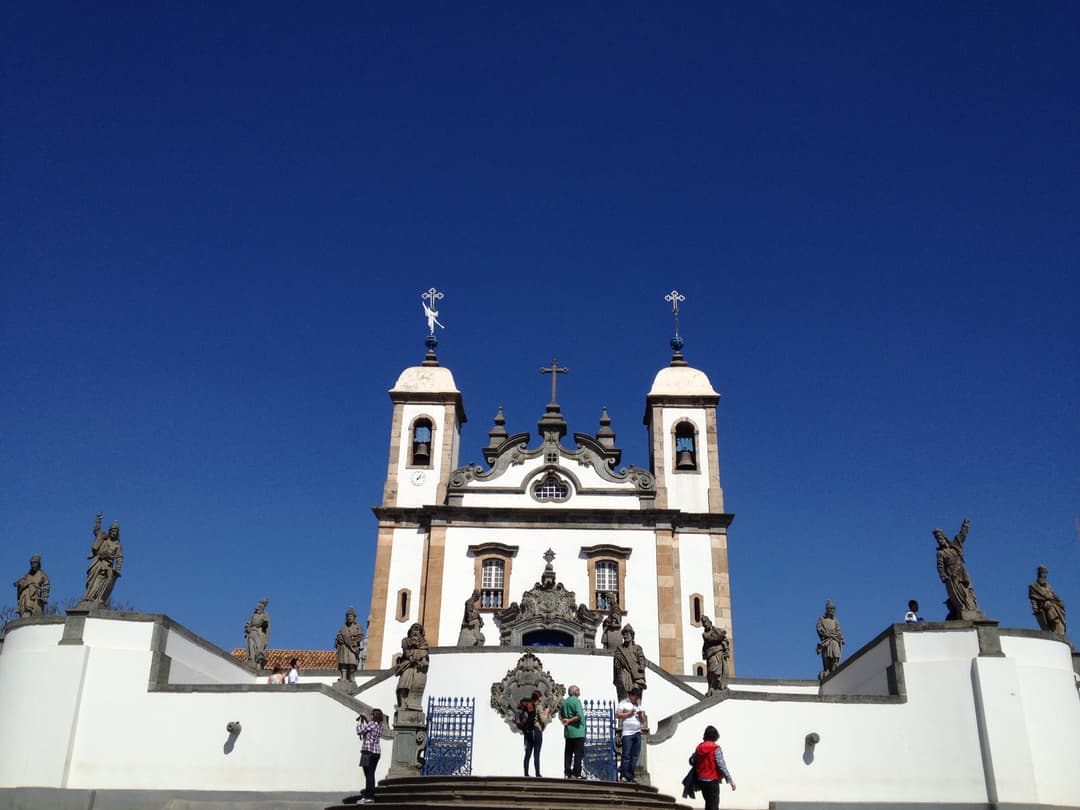 Low-angle view of the church facade and prophet statues on the terrace