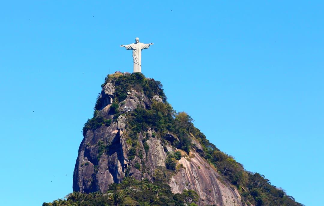 Distant view of Christ the Redeemer atop Corcovado under a clear blue sky
