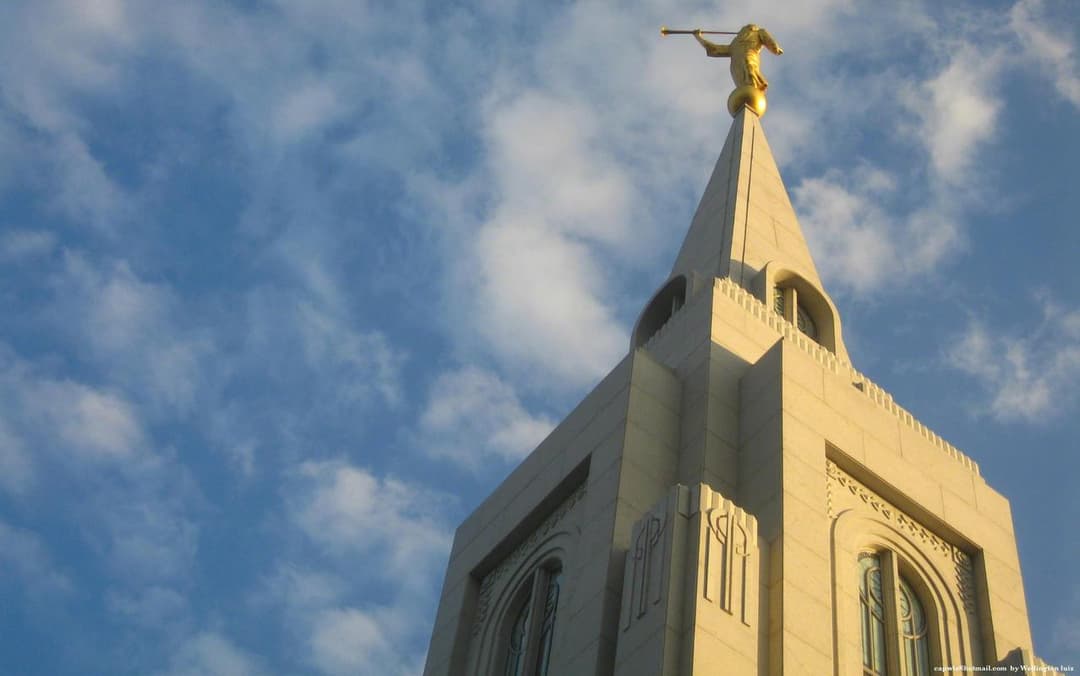 Low-angle view of the Curitiba Temple spire and Angel Moroni statue.