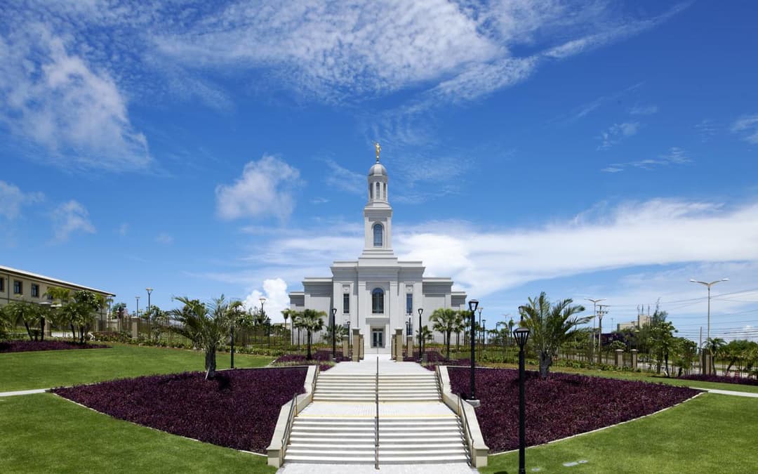 Fortaleza Brazil Temple, front view, with Angel Moroni, lawns, and purple plants.