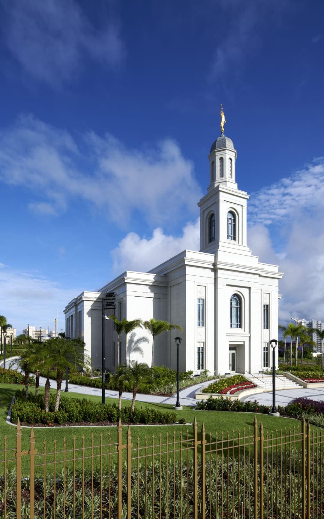 Fortaleza Brazil Temple exterior, daytime, with steeple, Angel Moroni, and gardens.