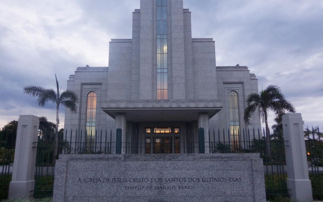 Manaus Brazil Temple front at dusk, with inscription and palm trees.
