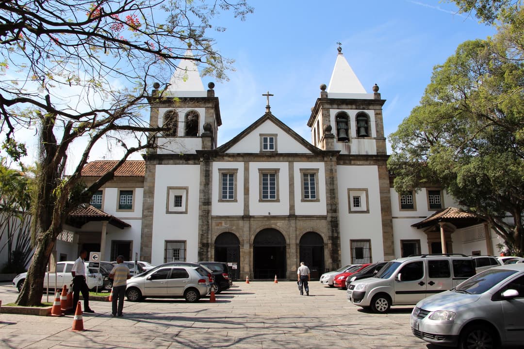 Front view of the monastery façade with twin spires and courtyard.