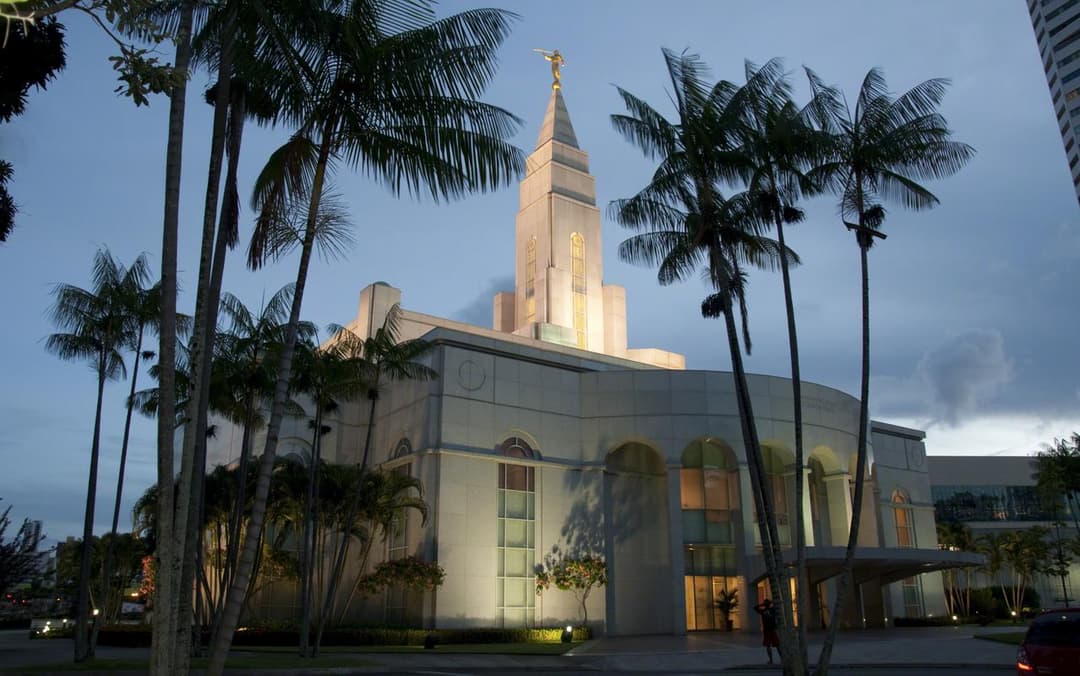 Exterior view of the illuminated Recife Brazil Temple at twilight.