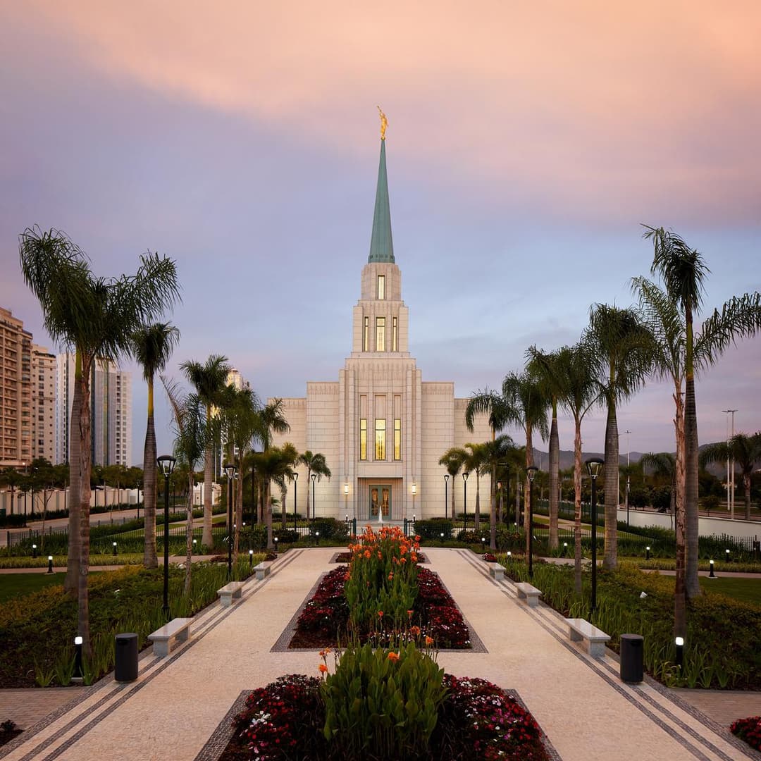 Front view of the Rio de Janeiro Temple with garden pathway at twilight.