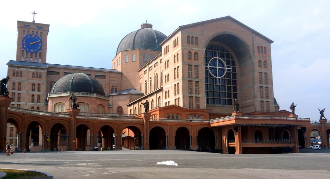 Wide-angle view of the exterior facade, central dome, and clock tower.