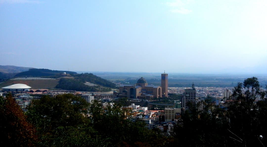 Distant panoramic view of the sanctuary complex, dome, and clock tower.