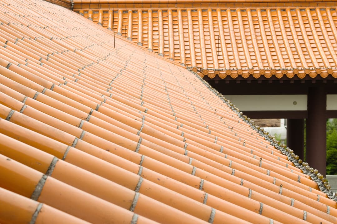Detail of the sweeping glazed yellow roof tiles at Templo Zu Lai.
