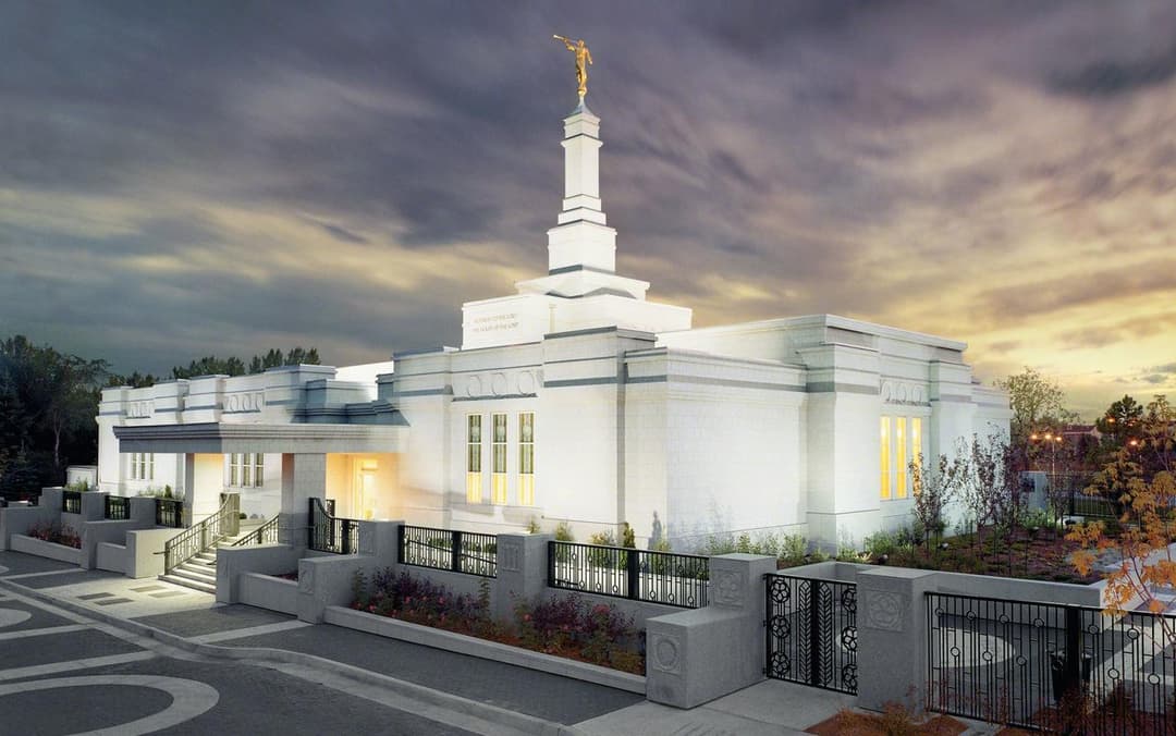 Edmonton Alberta Temple exterior at twilight, featuring Moroni statue and grounds.
