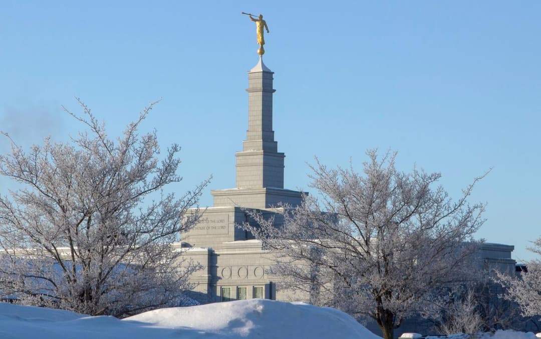 Edmonton Alberta Temple in winter with frosted trees and Angel Moroni.