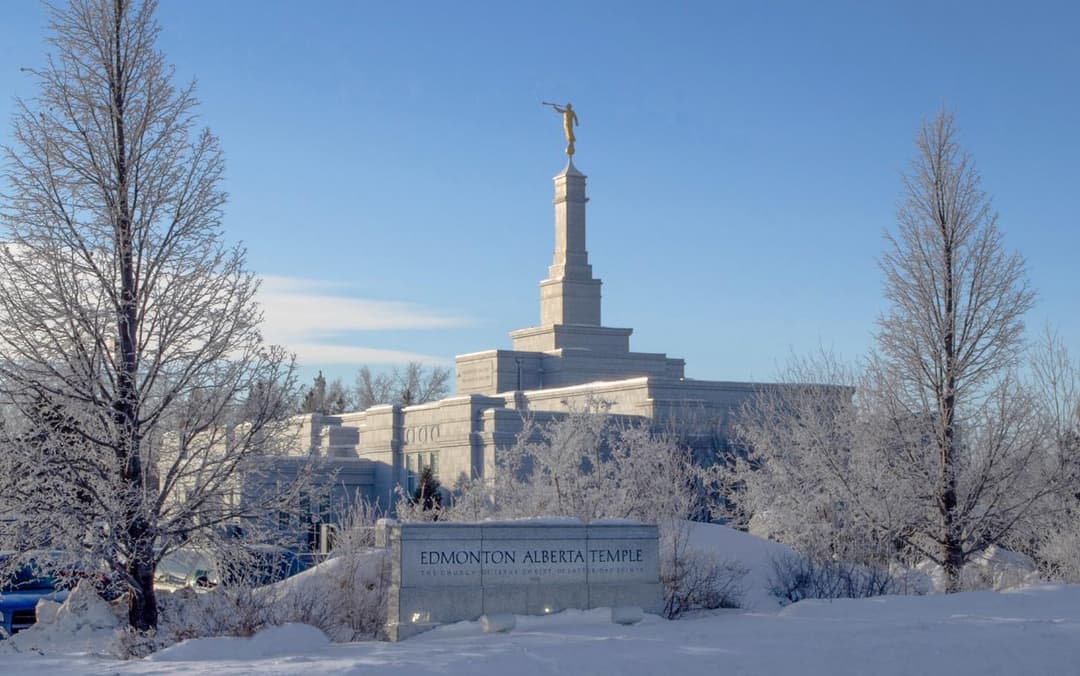 Edmonton Alberta Temple exterior, winter, frosted trees, Angel Moroni, blue sky.