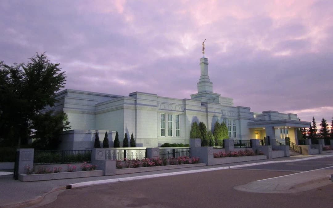 Edmonton Alberta Temple exterior at twilight with Angel Moroni spire.