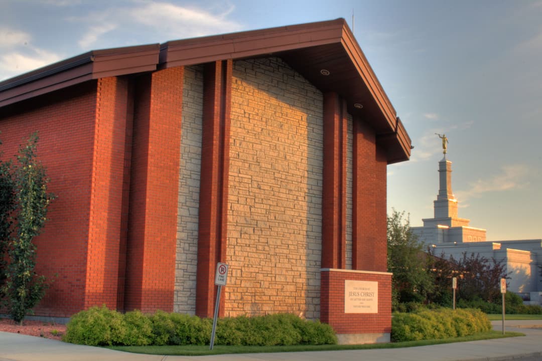 Edmonton Alberta Temple complex exterior, spire visible in warm light.