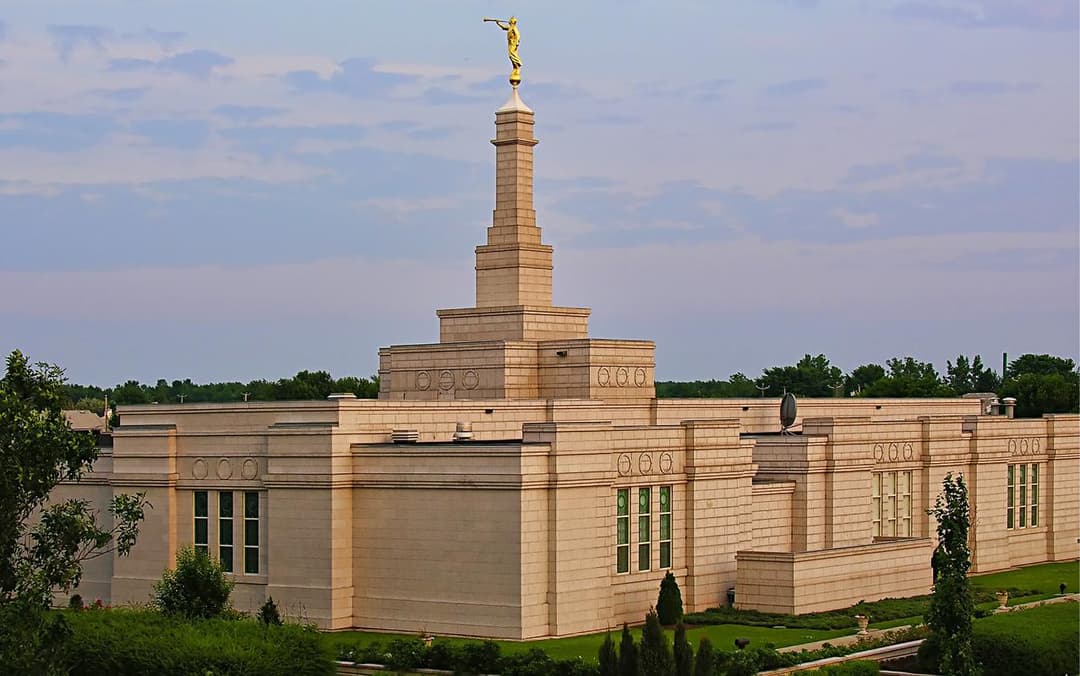 Montreal Quebec Temple exterior at golden hour, featuring its spire and Angel Moroni.