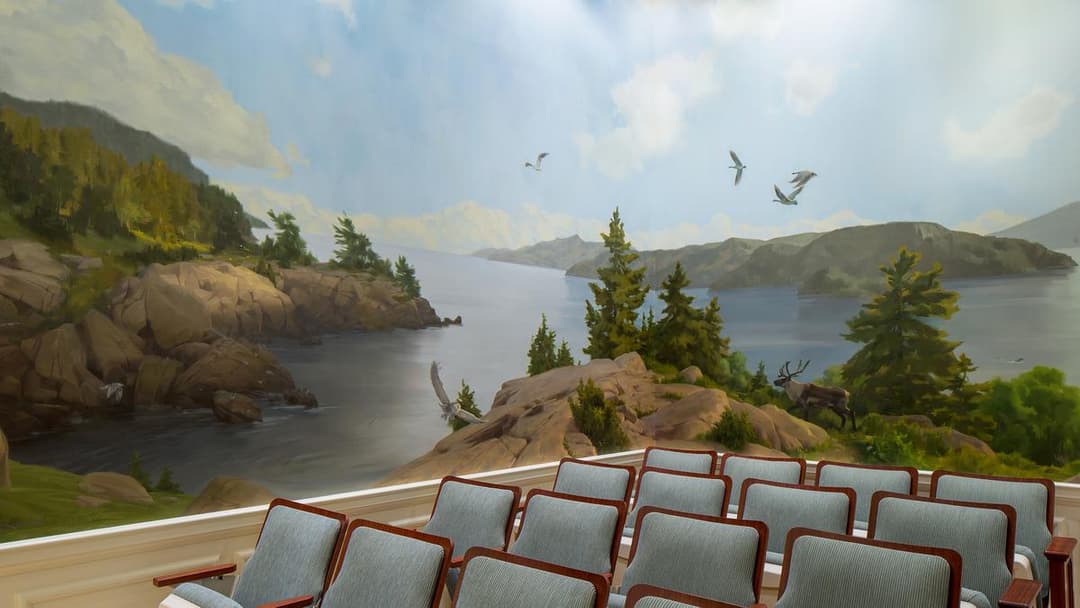 Interior view of a room with a nature mural and rows of chairs.