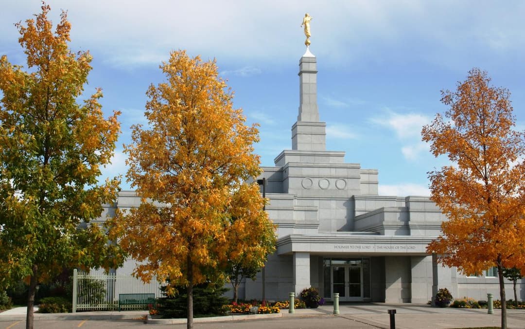 Front entrance of the Regina Saskatchewan Temple framed by autumn foliage.