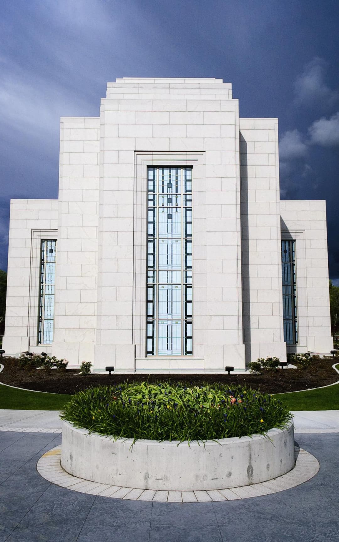 Symmetrical view of the stepped stone facade and central planter.