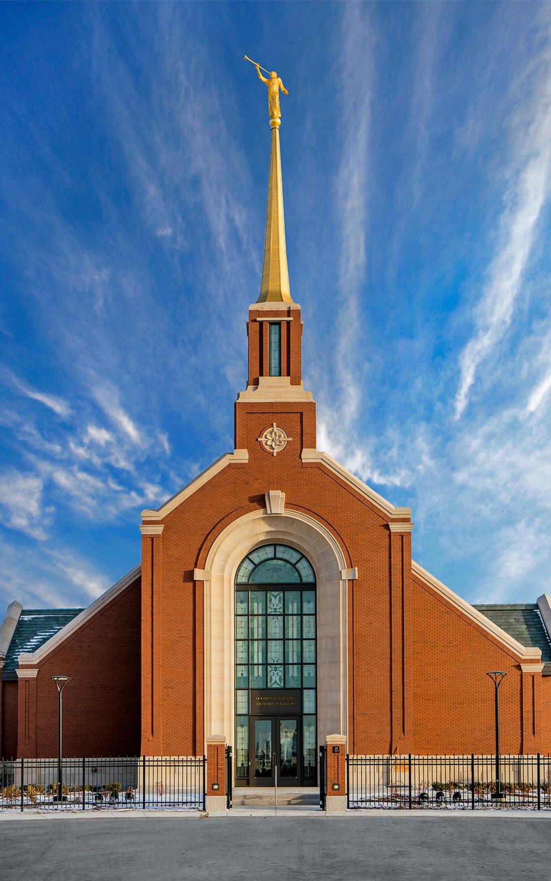Front entrance view of the Winnipeg Manitoba Temple under a blue sky.