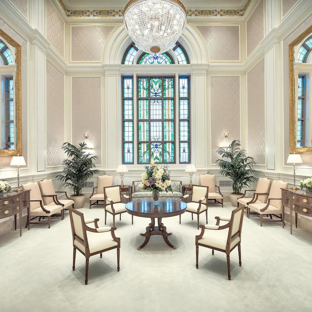The Celestial Room featuring elegant seating and a crystal chandelier.