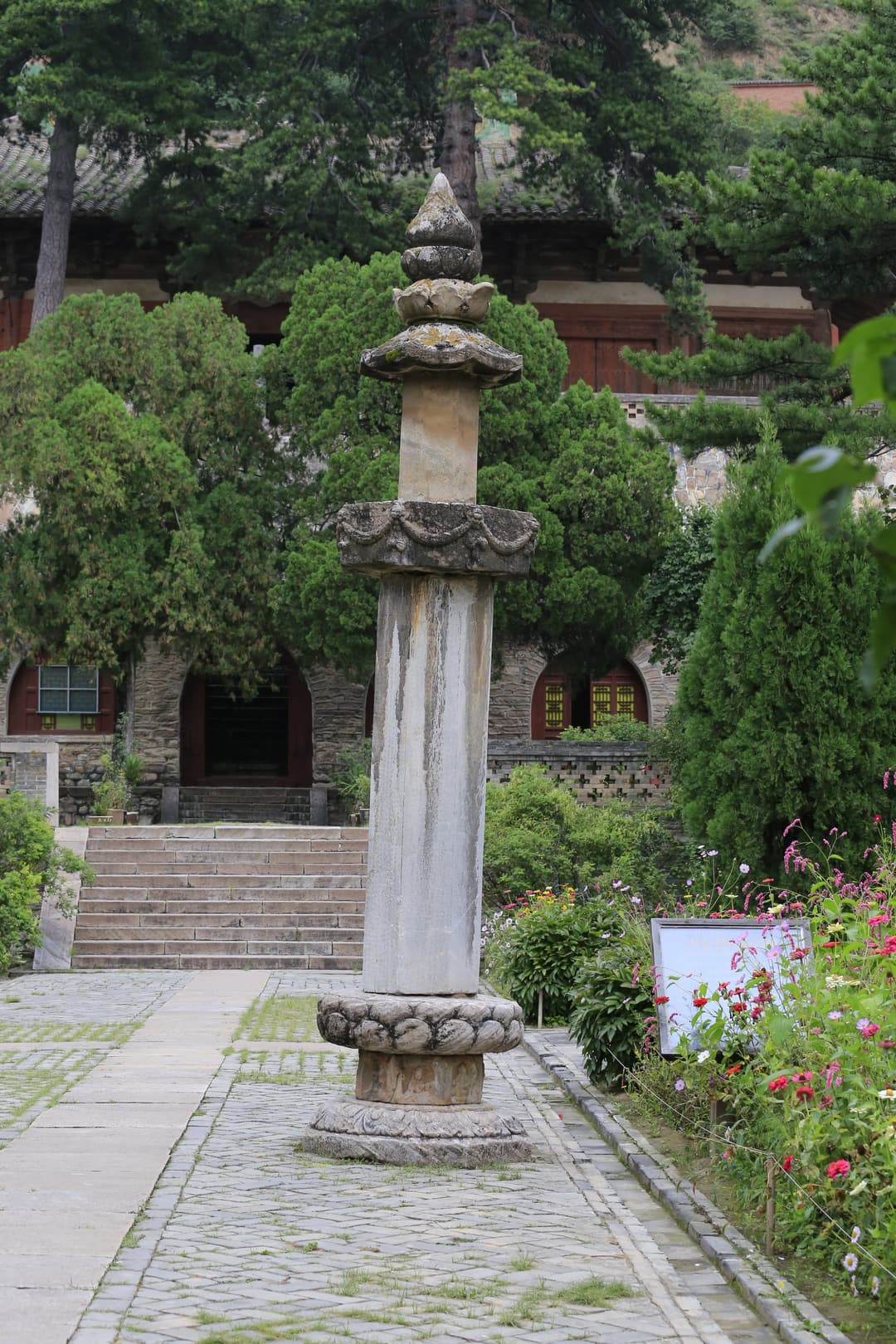 Stone dharani pillar along a courtyard path at Foguang Temple