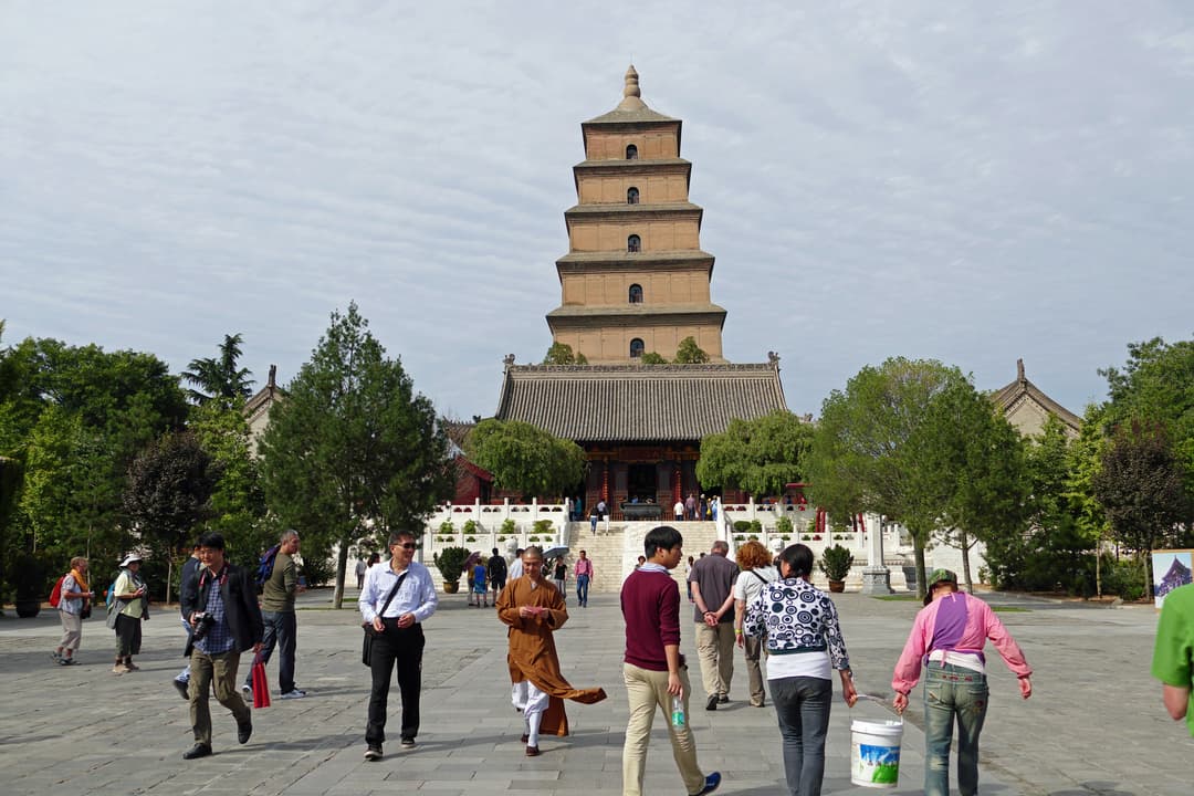 Courtyard view of the Giant Wild Goose Pagoda rising behind a temple hall.