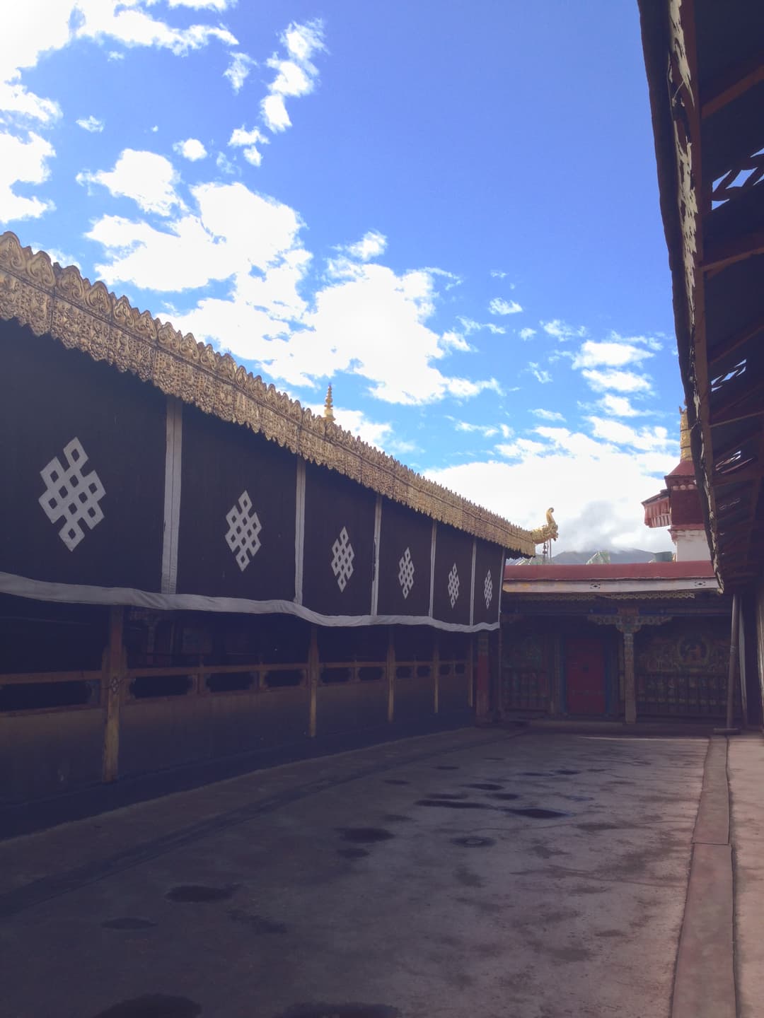 Upper courtyard at Jokhang Temple with traditional endless knot curtains