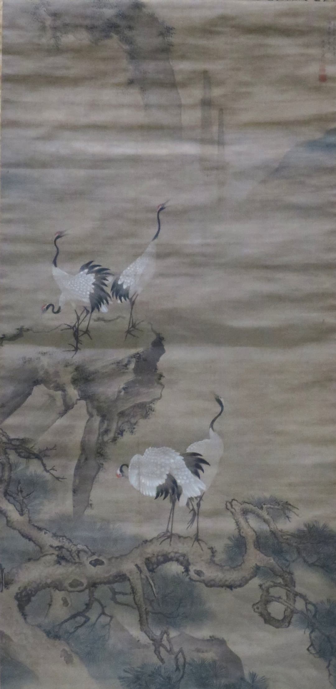 Traditional scroll painting depicting red-crowned cranes on pine and rock