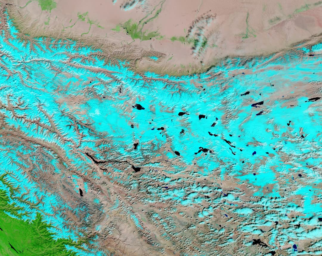 False-color satellite view of the snow-covered Kunlun Mountains.