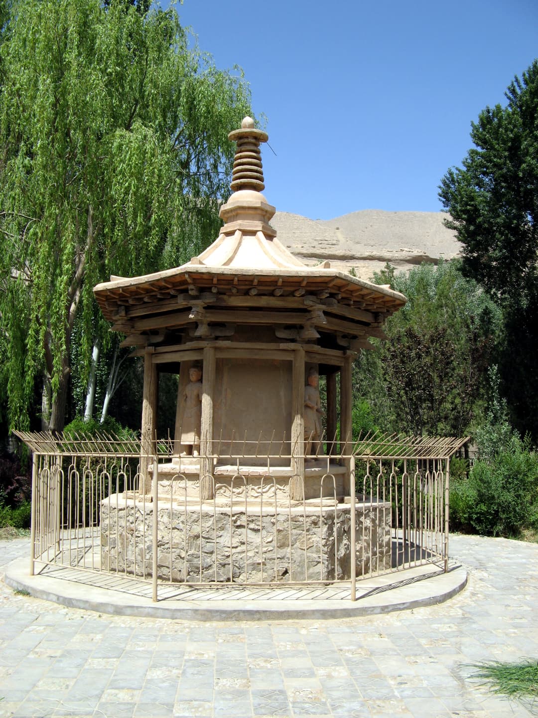Octagonal wooden stupa shrine on the grounds of the Mogao Caves.