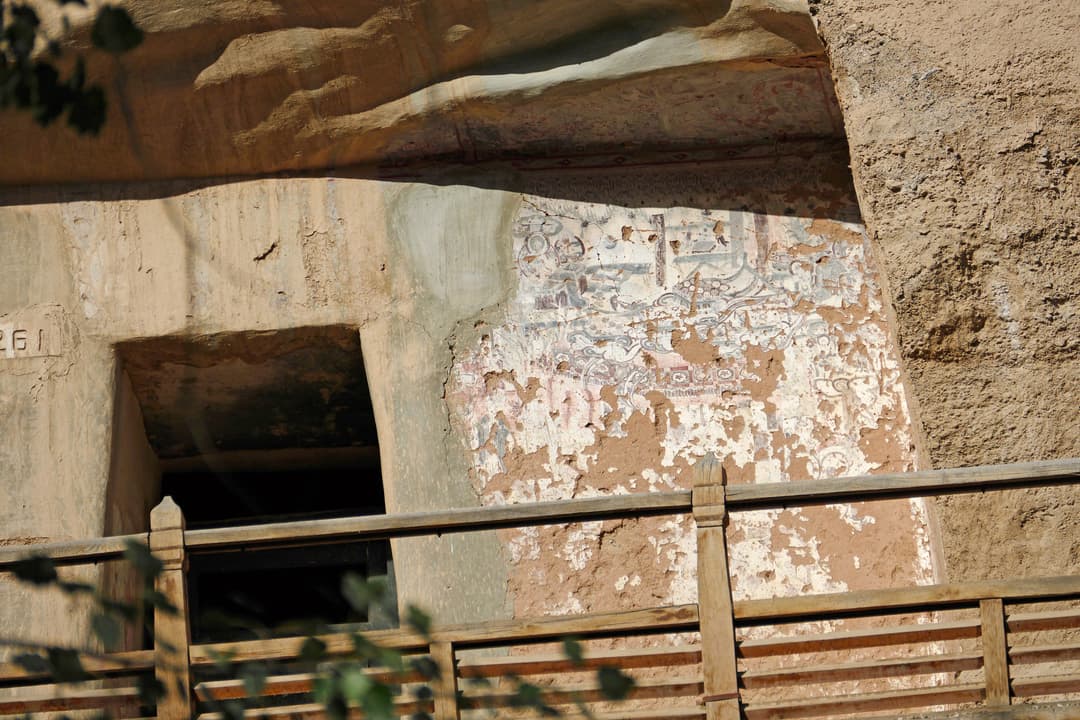 Detail of weathered murals and entrance of Cave 261 at the Mogao Caves.