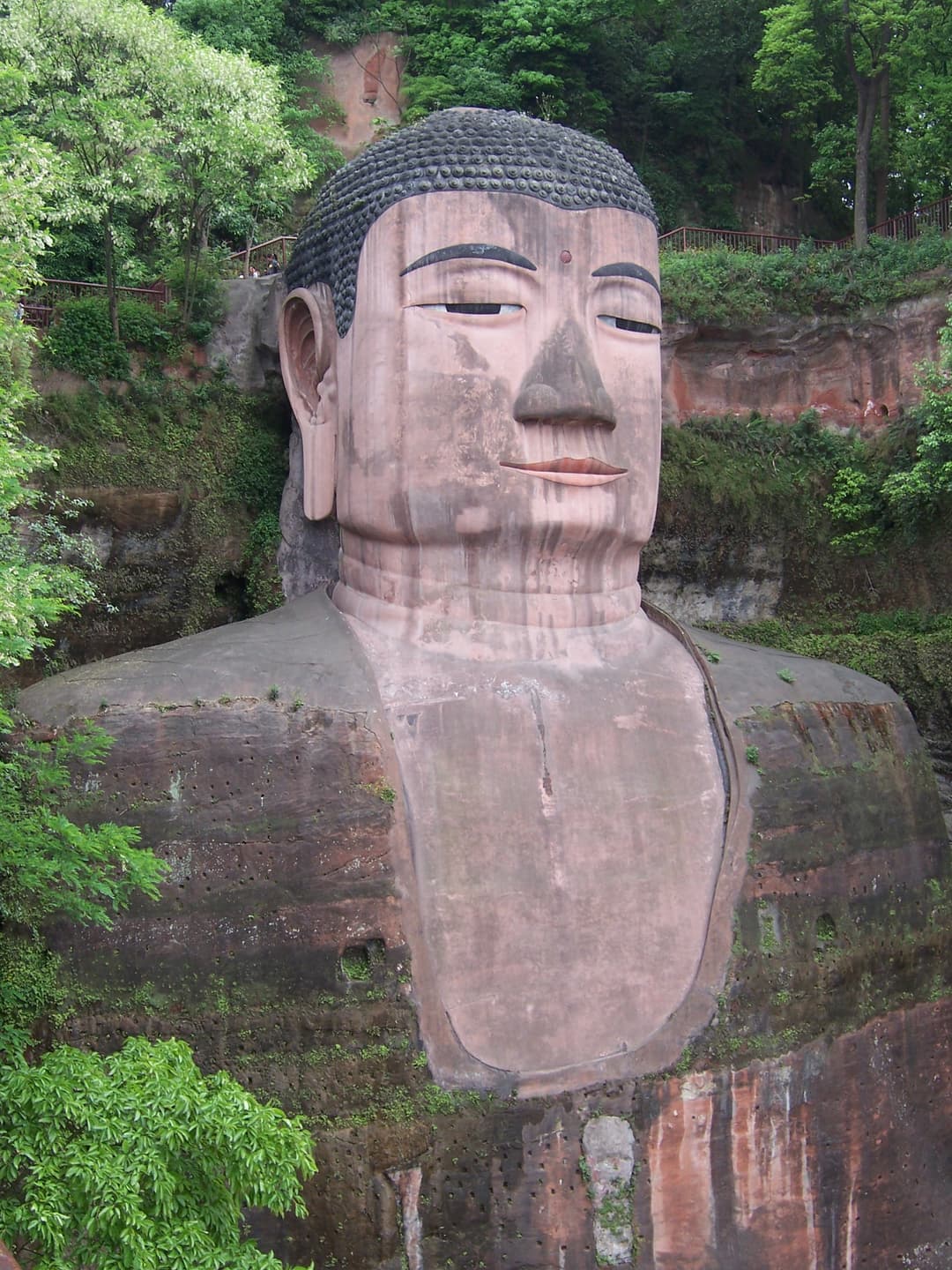 Close-up view of the head and torso of the Leshan Giant Buddha.