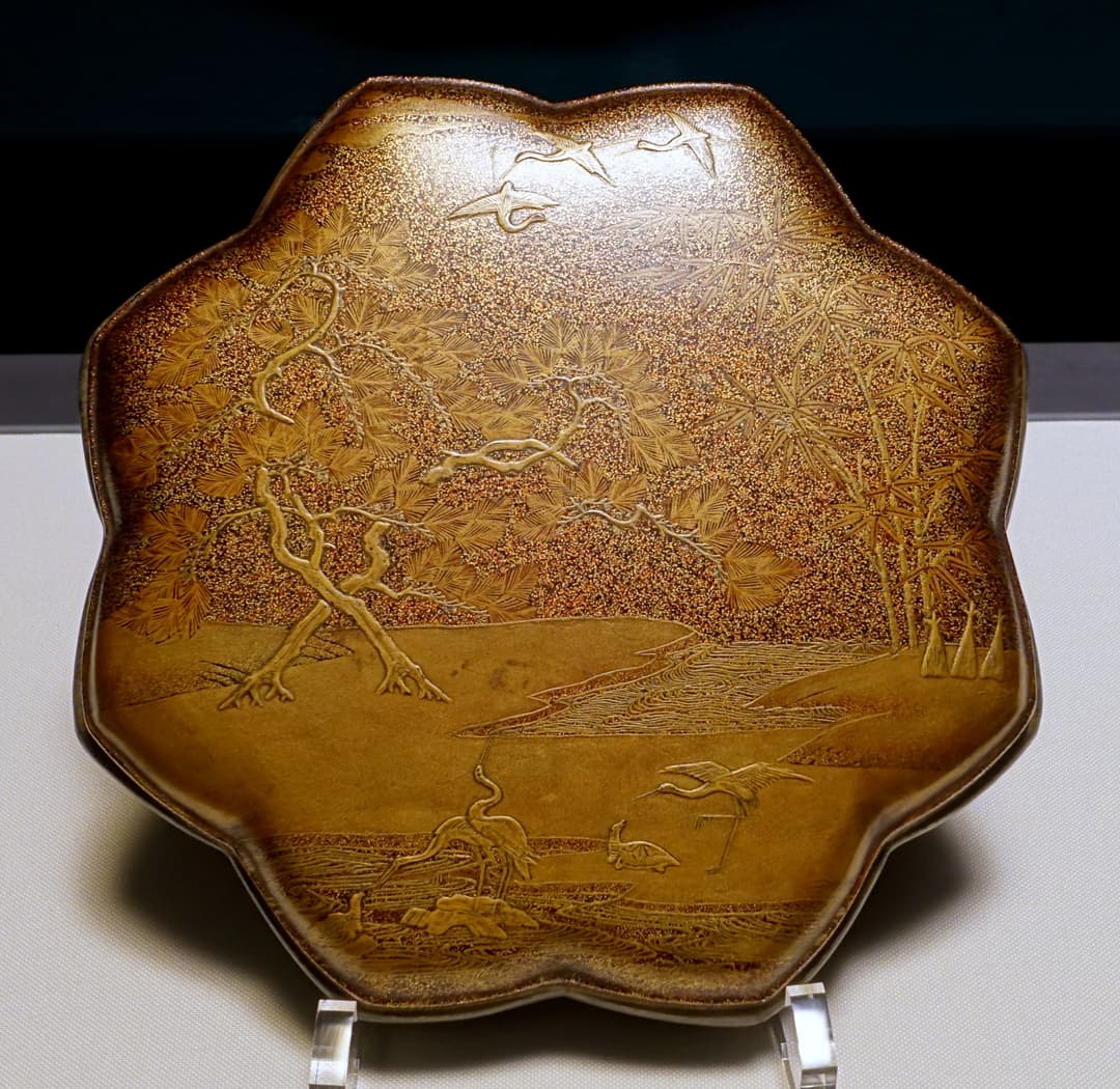 Gold lacquer lobed tray with cranes and pine landscape on display