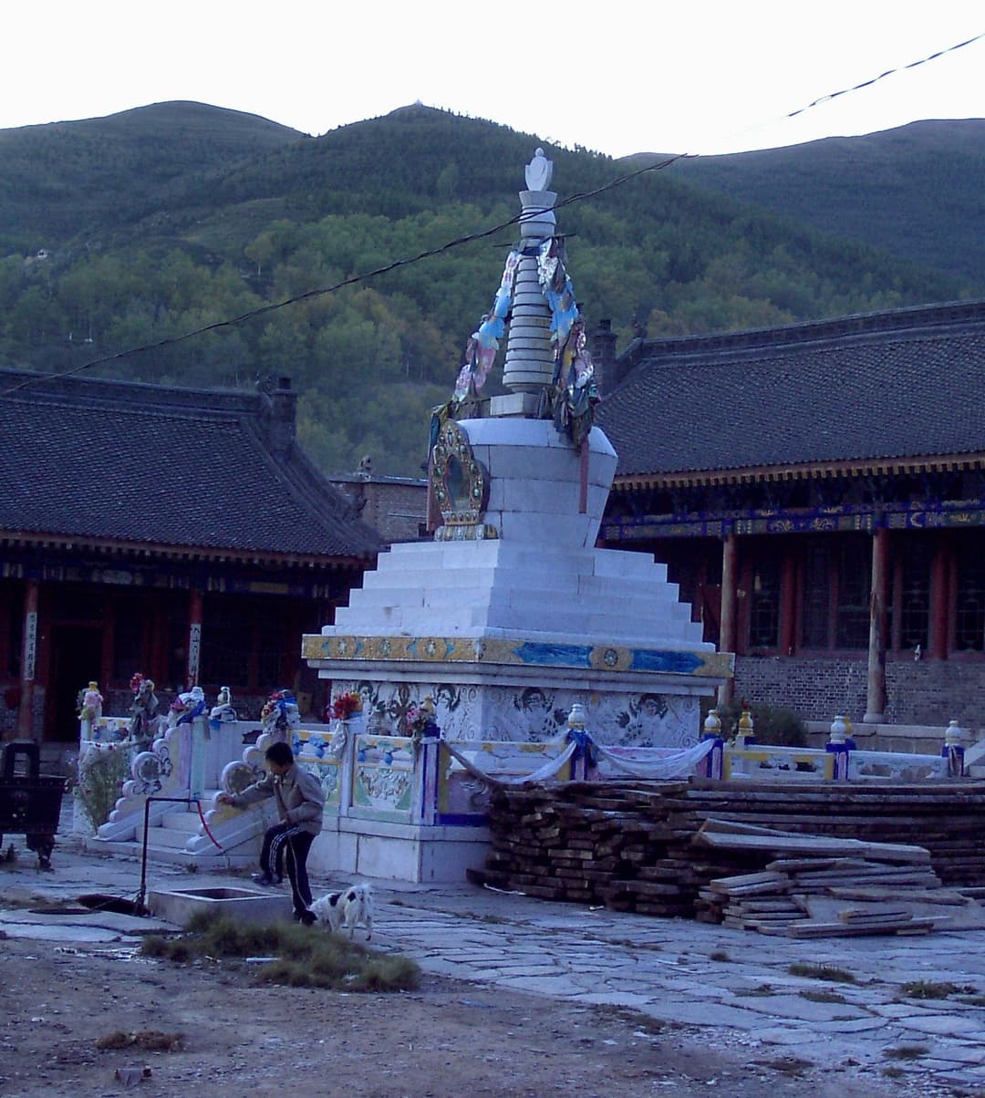 White stupa in a monastery courtyard at Mount Wutai at twilight.