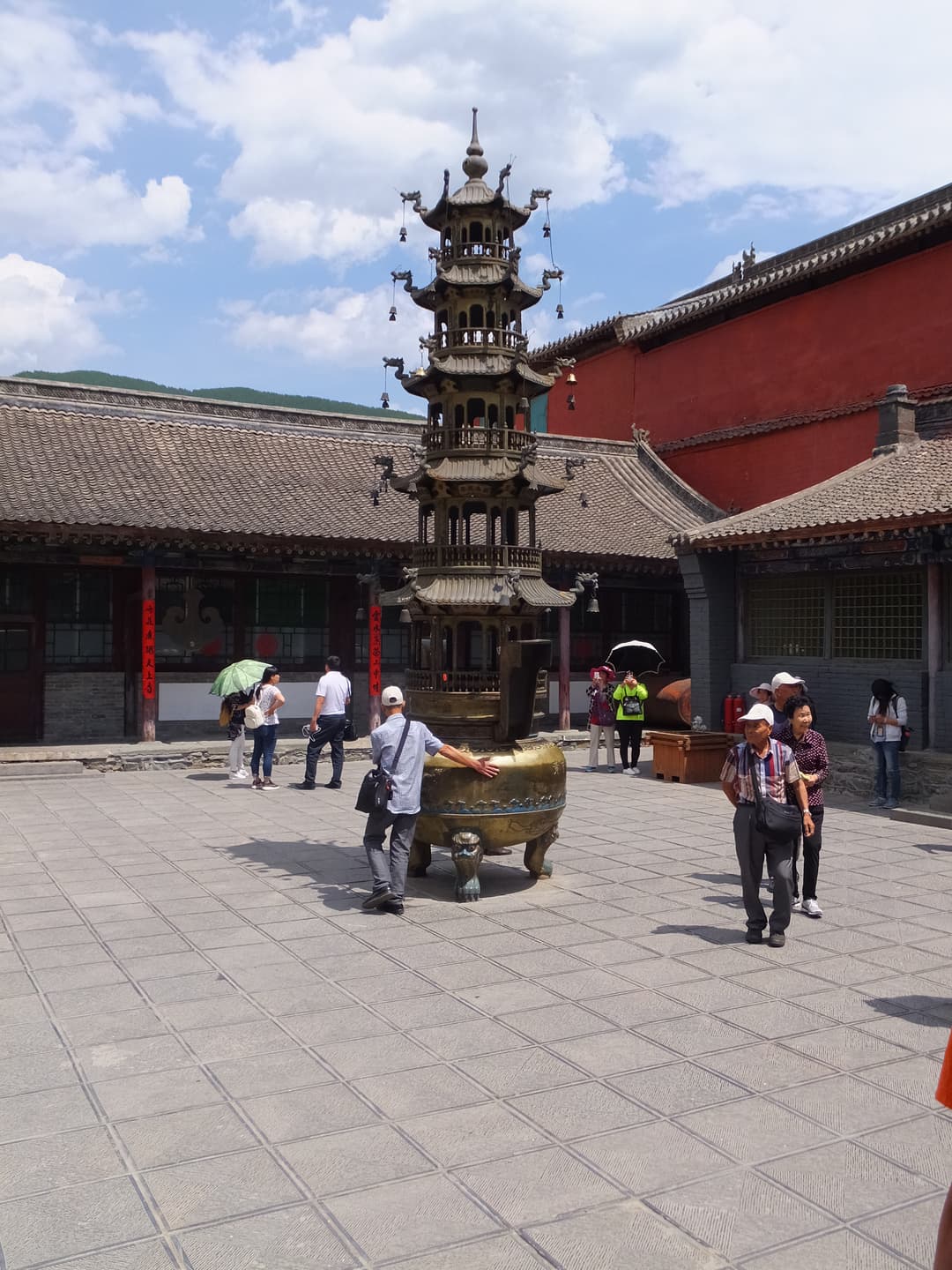 Multi-tiered bronze incense pagoda in a temple courtyard at Mount Wutai.