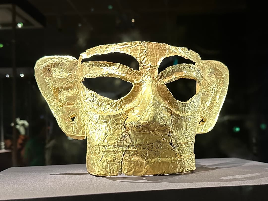Gold mask artifact displayed in the Sanxingdui Museum gallery.