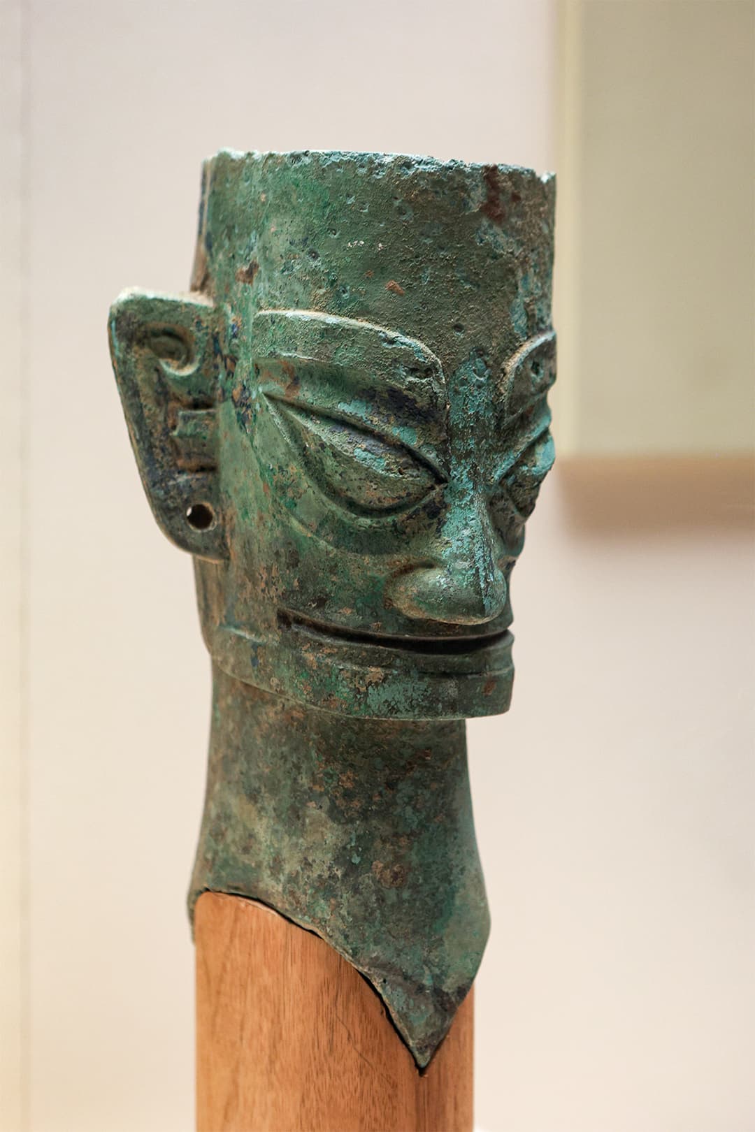 Interior display of an ancient bronze head sculpture at Sanxingdui Museum.