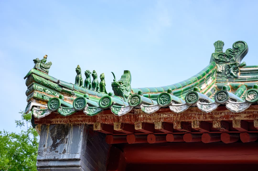 Detail of green-glazed roof ridge beasts on temple eaves, Shaolin Temple