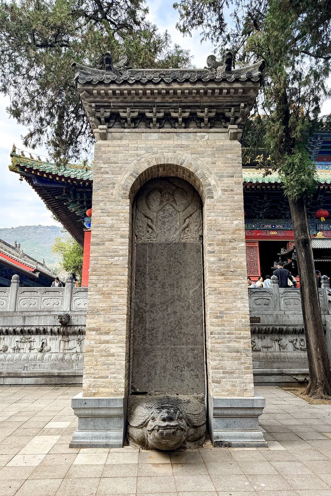 Turtle-borne stone stele inside a brick pavilion at Shaolin Temple.