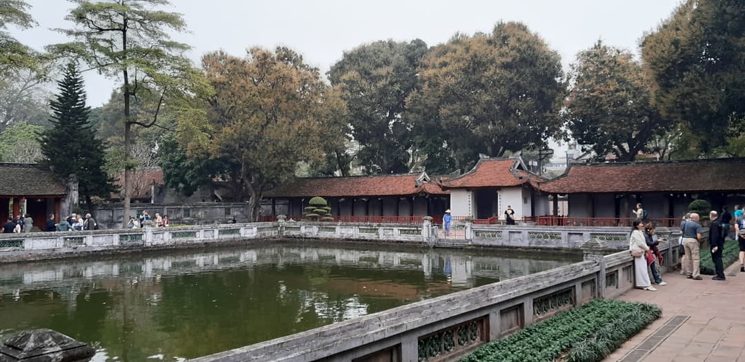 Courtyard view of the rectangular reflection pond and traditional pavilions.