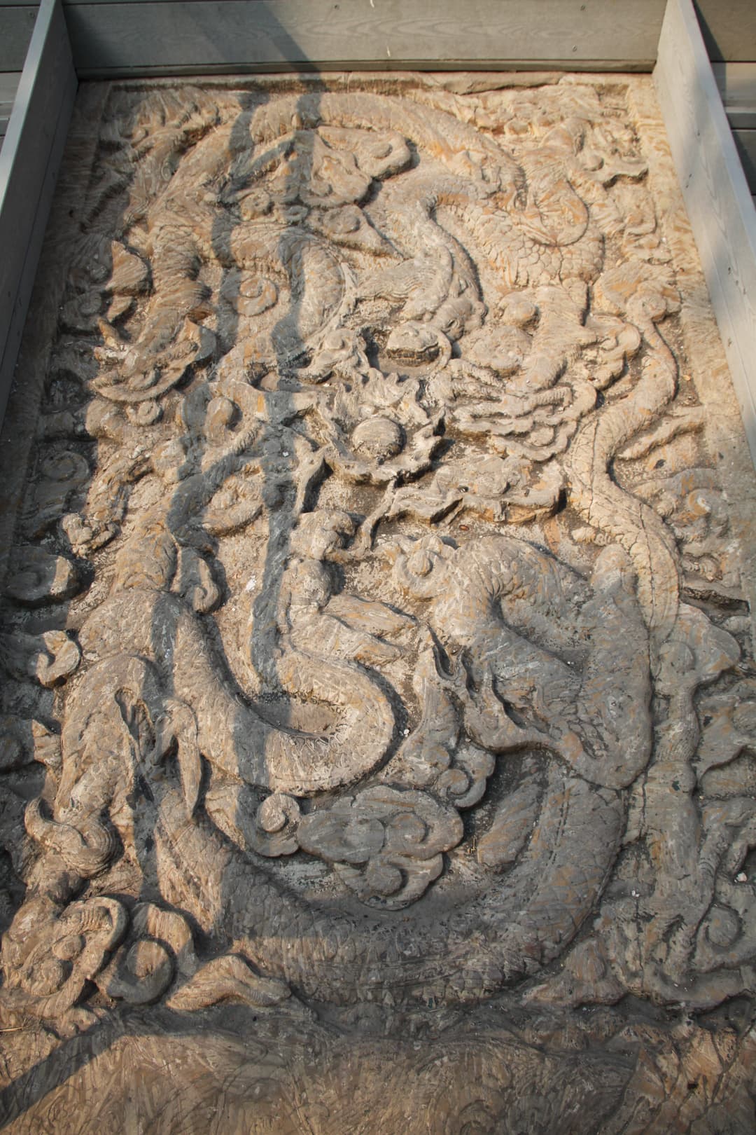 Intricately carved stone dragon relief at the Temple of Confucius in Qufu.