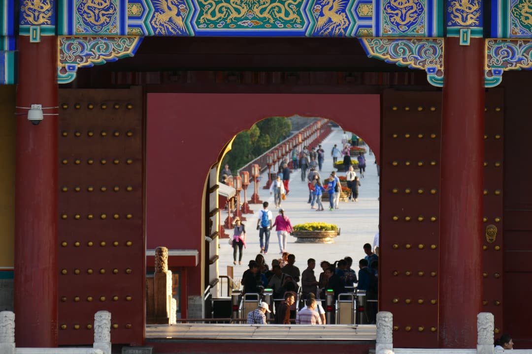 View through an ornate gate toward visitors on Danbi Bridge