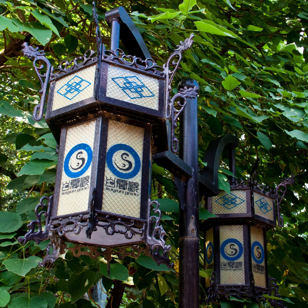 Ornate Taoist lanterns with Baiyun Guan emblems on the temple grounds.