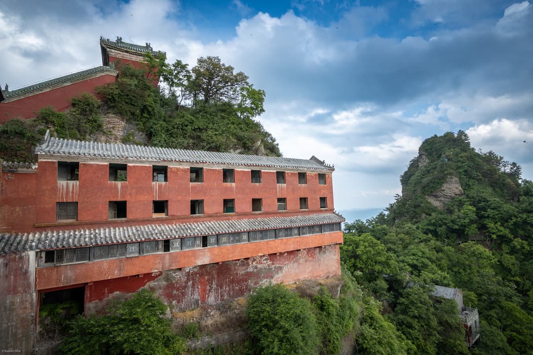 Wudang Mountains architecture: exterior of a red, tiled building on a mountainside.