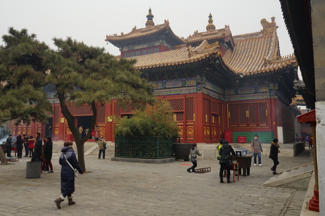 Courtyard view of the Hall of the Wheel of the Law with visitors.