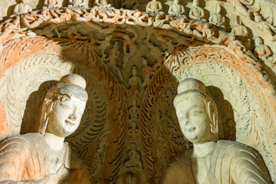 Interior view of twin Buddha statues carved inside a Yungang Grottoes niche.