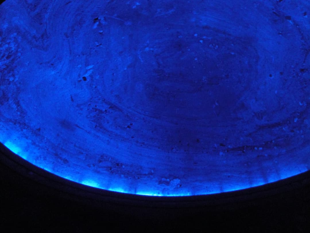 Interior view of a carved salt dome ceiling illuminated in blue.