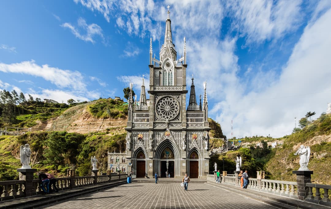 Exterior view of the Sanctuary of Las Lajas nestled in the canyon.
